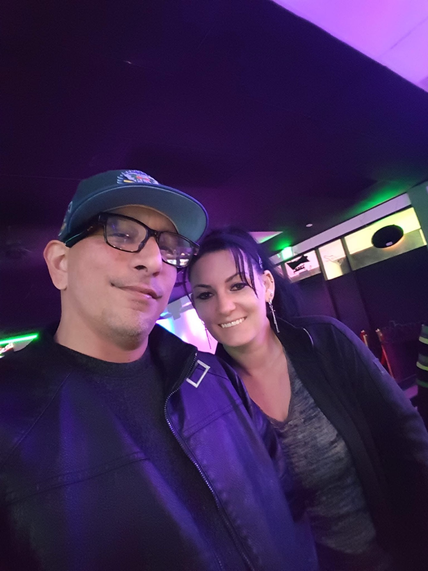 DJ R Styles with a fan under purple lights